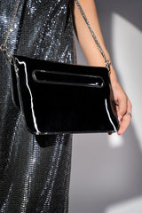 Womens patent leather clutch bag in black colour with twist lock and detachable silver chain strap by JULKE