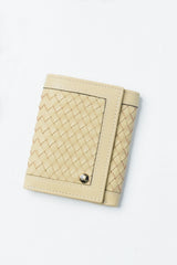 Womens leather trifold wallet in light yellow colour with braiding and metal logo by JULKE