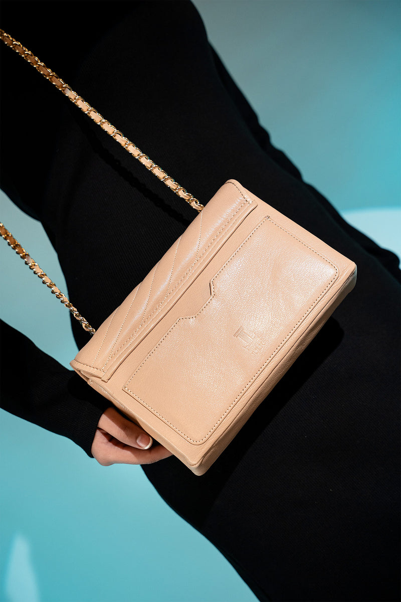 Women's leather shoulder bag in beige brown colour with quilting and leatherette flower brooch by JULKE. 