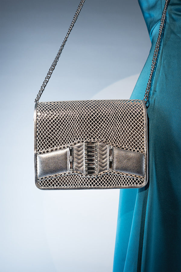 Women's leather reptile texture shoulder clutch bag in silver colour with rhinestones and detachable golden shoulder chain by JULKE. 