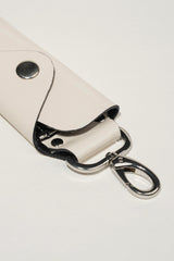 Leather key ring set in glossy off white colour with silver metal hook by JULKE