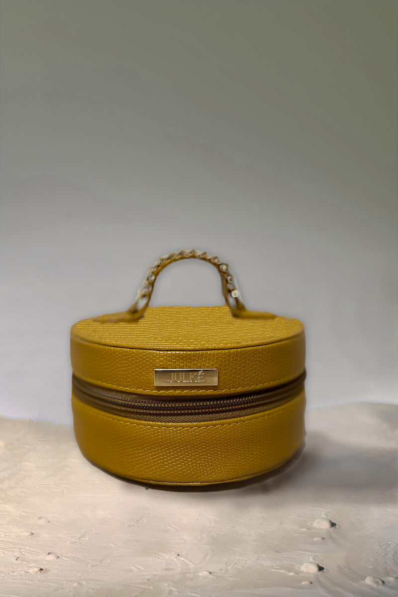 Women's leather round bag in mustard yellow colour for jewellery and accessories  with top handle by JULKE