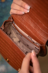 Womens leather handbag in brown colour with croc texture, round handle and wristlet by JULKE